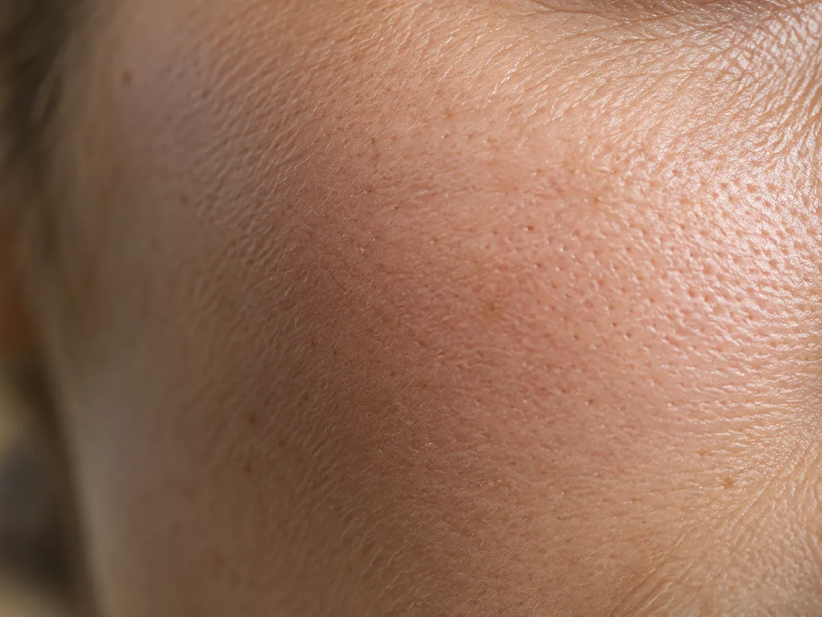 Close view of natural skin texture and pores in soft side light